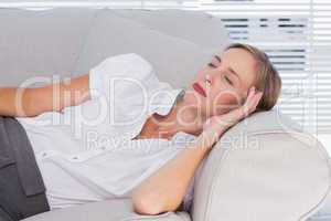 Businesswoman sleeping on couch