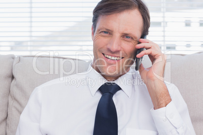 Cheerful businessman calling