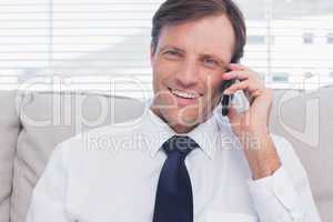 Cheerful businessman calling