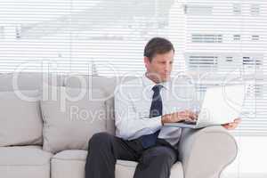 Confident businessman sitting on couch