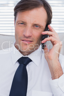 Portrait of a serious businessman talking on phone