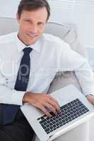 Businessman typing on his laptop