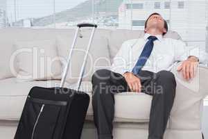 Businessman napping on couch