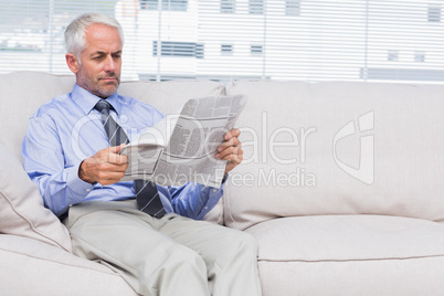 Businessman reading newspaper