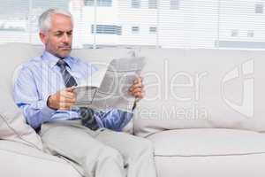 Businessman reading newspaper