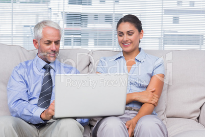 Business people looking at laptop