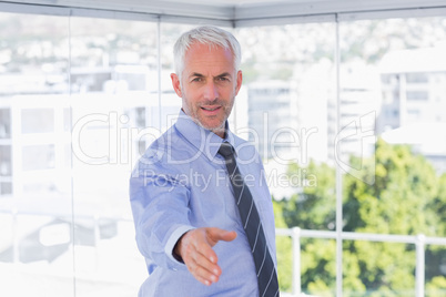 Happy businessman extending arm for handshake