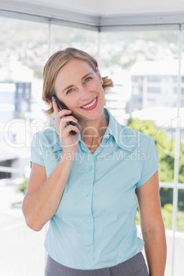 Smiling businesswoman holding smartphone Smiling businesswoman holding smartphone