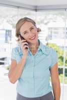 Smiling businesswoman holding smartphone