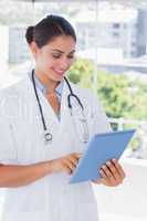Pretty young doctor using tablet pc