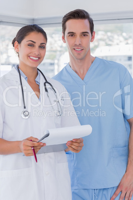 Doctor and surgeon smiling at the camera