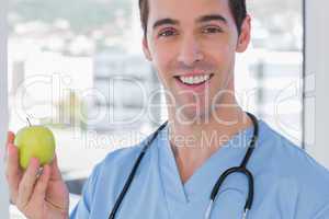 Practitioner holding a green apple