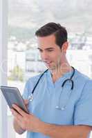 Male nurse working on a tablet pc