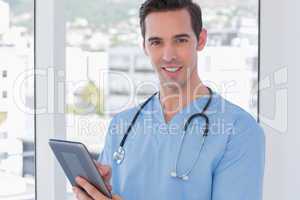 Male nurse holding a digital tablet