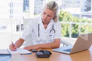 Attractive nurse working in her office