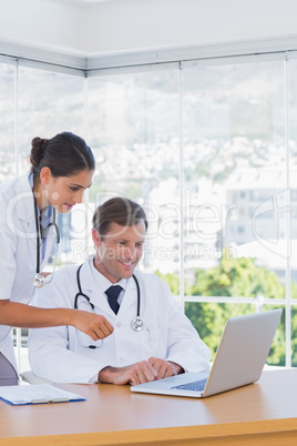 Doctors working together on a laptop