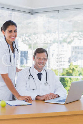 Cheerful doctors posing together in their office