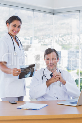Cheerful group of doctors working on a x ray