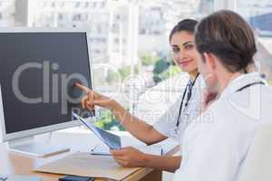 Doctor showing the screen of a computer to a colleague