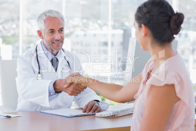 Doctor shaking hands to patient
