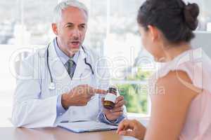 Doctor explaining the pills to patient