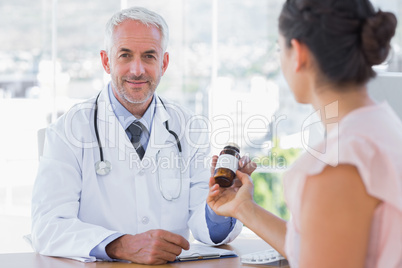 Patient holding a bottle of pills