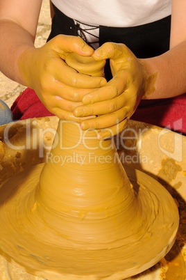 hands working the clay