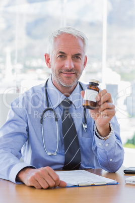 Attractive doctor holding medicine jar