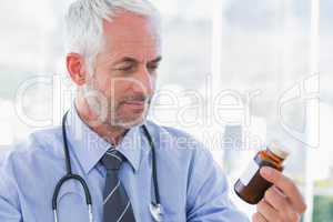 Doctor looking at medicine jar