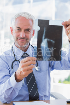 Attractive doctor showing a radiography