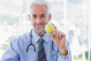 Doctor holding an apple in his hand