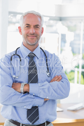 Attractive doctor with  his arms crossed