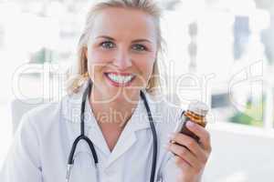 Attractive nurse holding a medicine jar