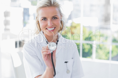 Radiant nurse showing her stethoscope