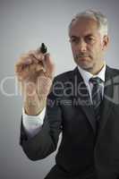 Attractive businessman holding a marker