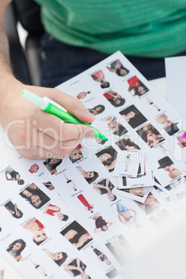 Photo editor marking photographs of contact