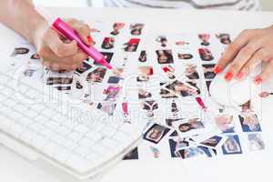 Female photo editor working on a contact sheet