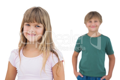 Girl smiling with boy behind her