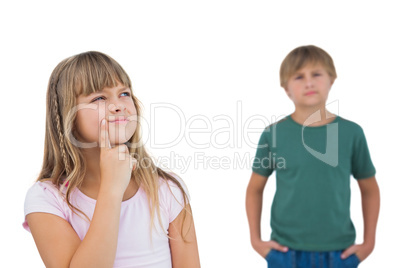 Little girl thinking with boy behind her