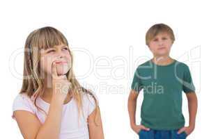 Little girl thinking with boy behind her