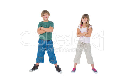 Smiling children with their arms crossed