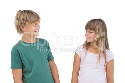 Little girl and boy looking at each other and smiling