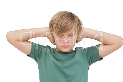 Blonde boy covering his ears with his eyes closed