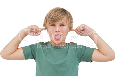 Blonde boy blocking his ears with fingers