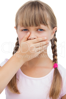 Little blond girl with her hand on her mouth