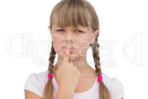 Young girl with her finger on her mouth