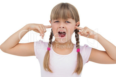 Little girl clogging her ears with her fingers