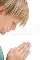 Little boy praying with eyes closed