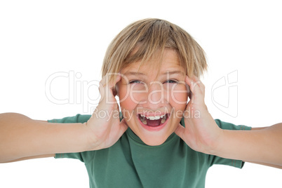 Cute boy shouting and covering his ears