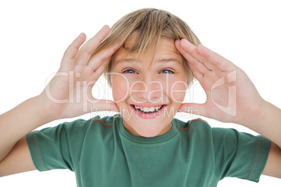 Surpised boy smiling with hands raised